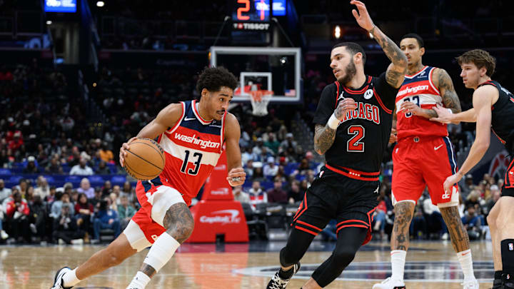 Jan 1, 2025; Washington, District of Columbia, USA; Washington Wizards guard Jordan Poole (13) drives to the basket against Chicago Bulls guard Lonzo Ball (2) during the first quarter at Capital One Arena. Mandatory Credit: Reggie Hildred-Imagn Images