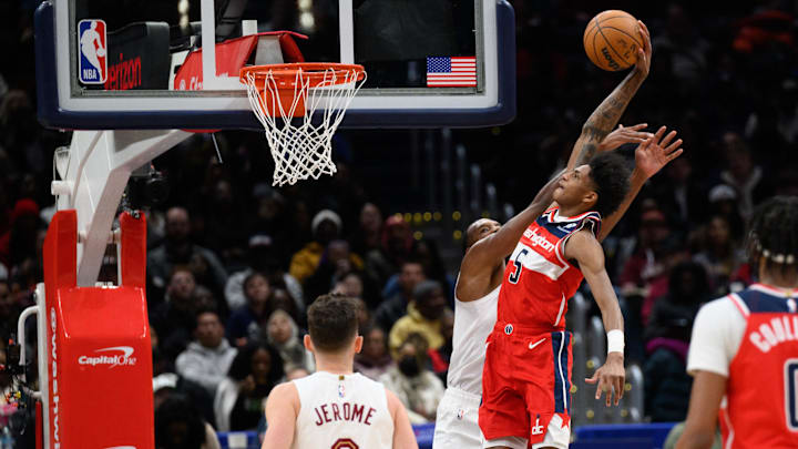 Feb 7, 2025; Washington, District of Columbia, USA; Washington Wizards guard AJ Johnson (5) dunks the ball over Cleveland Cavaliers forward Evan Mobley (4) during the third quarter at Capital One Arena. Mandatory Credit: Reggie Hildred-Imagn Images