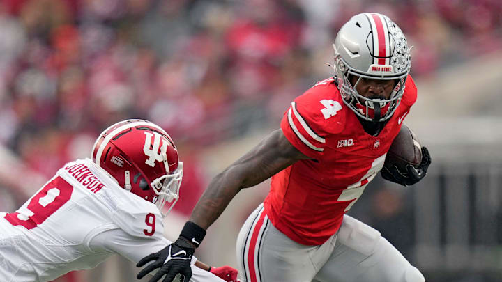 Ohio State Buckeyes wide receiver Jeremiah Smith (4) gets past Indiana Hoosiers defensive back Jamier Johnson (9) after a catch during the second quarter of the football game in Columbus on Saturday, Nov. 23, 2024.