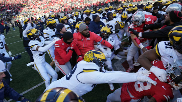 Michigan Wolverines defensive lineman Kenneth Grant (78) goes after Ohio State Buckeyes safety Jaylen McClain (18) after the game during a fight at the middle of the field after the NCAA football game at Ohio Stadium in Columbus on Saturday, Nov. 30, 2024.