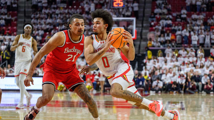 Dec 4, 2024; College Park, Maryland, USA; Maryland Terrapins guard Ja'Kobi Gillespie (0) drives to the basket against Ohio State Buckeyes forward Devin Royal (21) during the second half at Xfinity Center. Mandatory Credit: Reggie Hildred-Imagn Images