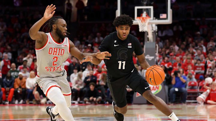 Jan 3, 2025; Columbus, Ohio, USA;  Michigan State Spartans guard Jase Richardson (11) dribbles past Ohio State Buckeyes guard Bruce Thornton (2) during the first half at Value City Arena. Mandatory Credit: Joseph Maiorana-Imagn Images
