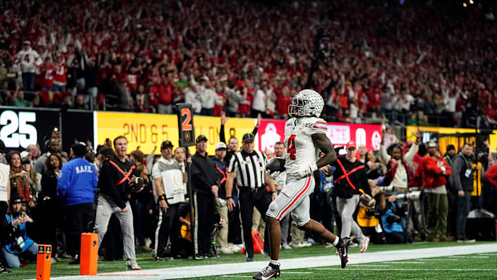 Ohio State Buckeyes wide receiver Jeremiah Smith (4) scores a touchdown after a catch against Notre Dame Fighting Irish in the first quarter during the College Football Playoff National Championship at Mercedes-Benz Stadium in Atlanta on January 20, 2025.