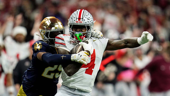 Ohio State Buckeyes wide receiver Jeremiah Smith (4) makes a catch against Notre Dame Fighting Irish cornerback Christian Gray (29) in the fourth quarter during the College Football Playoff National Championship at Mercedes-Benz Stadium in Atlanta on January 20, 2025.