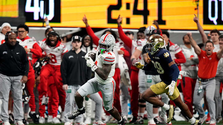 Ohio State Buckeyes wide receiver Jeremiah Smith (4) makes a catch against Notre Dame Fighting Irish cornerback Christian Gray (29) in the fourth quarter during the College Football Playoff National Championship at Mercedes-Benz Stadium in Atlanta on January 20, 2025.