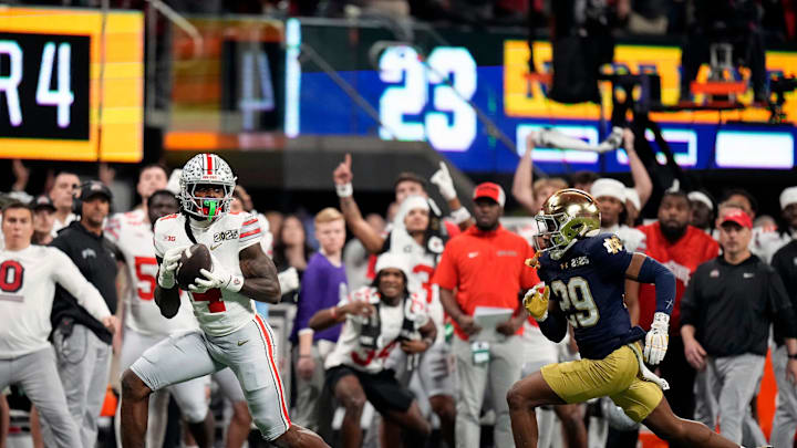 Ohio State Buckeyes wide receiver Jeremiah Smith (4) makes a catch against Notre Dame Fighting Irish cornerback Christian Gray (29) in the fourth quarter during the College Football Playoff National Championship at Mercedes-Benz Stadium in Atlanta on January 20, 2025.
