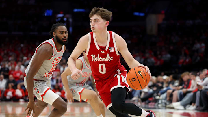 Mar 4, 2025; Columbus, Ohio, USA;  Nebraska Cornhuskers guard Connor Essegian (0) drives to the basket as Ohio State Buckeyes guard Evan Mahaffey (12) defends during the first half at Value City Arena. Mandatory Credit: Joseph Maiorana-Imagn Images