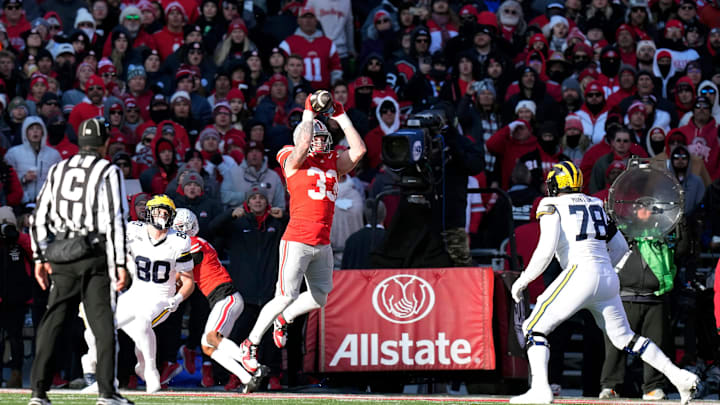 Ohio State Buckeyes defensive end Jack Sawyer (33) comes up with the interception of a Michigan Wolverines quarterback Davis Warren (16) pass during the fourth quarter of the NCAA football game at Ohio Stadium in Columbus on Saturday, Nov. 30, 2024.