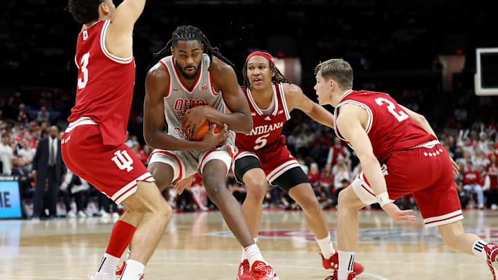 Feb 6, 2024; Columbus, Ohio, USA; Ohio State Buckeyes guard Evan Mahaffey (12) controls the ball as Indiana Hoosiers guard Anthony Leal (3) and guard Gabe Cupps (2) and forward Malik Reneau (5) defend during the second half at Value City Arena. Mandatory Credit: Joseph Maiorana-Imagn Images