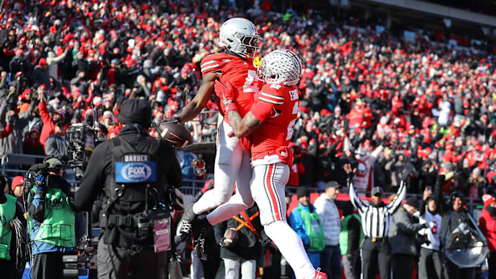 Nov 30, 2024; Columbus, Ohio, USA; Ohio State Buckeyes wide receiver Jeremiah Smith (4) celebrates his touchdown catch with wide receiver Emeka Egbuka (2) during the second quarter against the Michigan Wolverines at Ohio Stadium. Mandatory Credit: Joseph Maiorana-Imagn Images