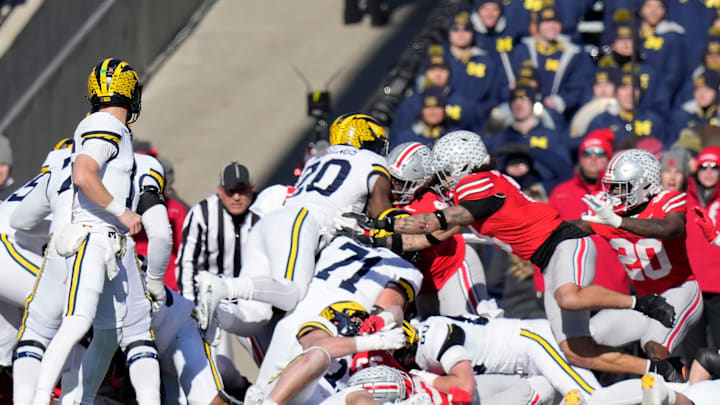 Ohio State Buckeyes defensive tackle Tyleik Williams (91) stops Michigan Wolverines running back Kalel Mullings (20) on a fourth down run on the goal line during the second quarter of the NCAA football game at Ohio Stadium in Columbus on Saturday, Nov. 30, 2024.