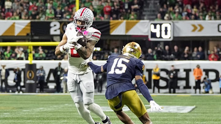 Ohio State Buckeyes wide receiver Emeka Egbuka (2) makes a catch against Notre Dame Fighting Irish cornerback Leonard Moore (15) in the third quarter during the College Football Playoff championship at Mercedes-Benz Stadium in Atlanta on January 20, 2025.