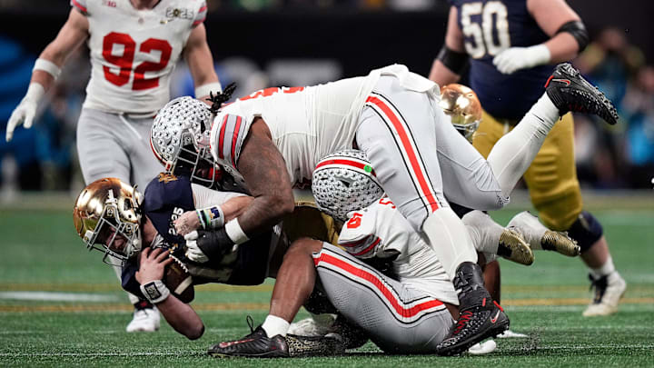 Ohio State Buckeyes safety Sonny Styles (6) and defensive tackle Tyleik Williams (91) sacks Notre Dame Fighting Irish quarterback Riley Leonard (13) in the third quarter during the College Football Playoff championship at Mercedes-Benz Stadium in Atlanta on January 20, 2025.