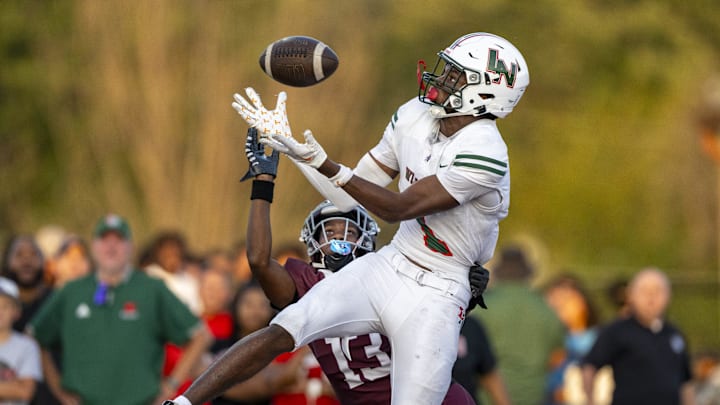 Lawrence North High School sophomore Monshun Sales (1) makes a catch in the end zone to score while being defended by Lawrence Central High School junior DJ Summers (13) during the first half of an IHSAA varsity football game, Friday, Aug. 23, 2024, at Lawrence Central High School. Lawrence North High School sophomore Monshun Sales (1) makes a catch in the end zone to score while being defended by Lawrence Central High School junior DJ Summers (13) during the first half of an IHSAA varsity football game, Friday, Aug. 23, 2024, at Lawrence Central High School.
