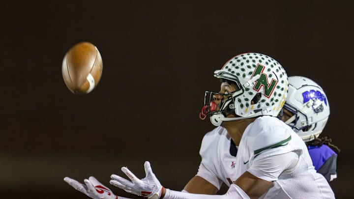 Lawrence North High School sophomore Monshun Sales (1) makes a reception for a 38-yard gain during the first half of an IHSAA Class 6A Regional Championship game against Brownsburg High School, Friday, Nov. 15, 2024, at Brownsburg High School.