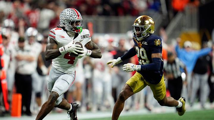 Ohio State Buckeyes wide receiver Jeremiah Smith (4) makes a catch against Notre Dame Fighting Irish cornerback Christian Gray (29) in the fourth quarter during the College Football Playoff National Championship at Mercedes-Benz Stadium in Atlanta on January 20, 2025.