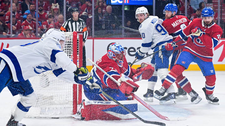 May 1, 2026; Montreal, Quebec, CAN; Montreal Canadiens goalie Jakub Dobes (75) pokes the puck away from Tampa Bay Lightning forward Jake Guentzel (59) during the second period in game six of the first round of the 2026 Stanley Cup Playoffs at the Bell Centre. Mandatory Credit: Eric Bolte-Imagn Images