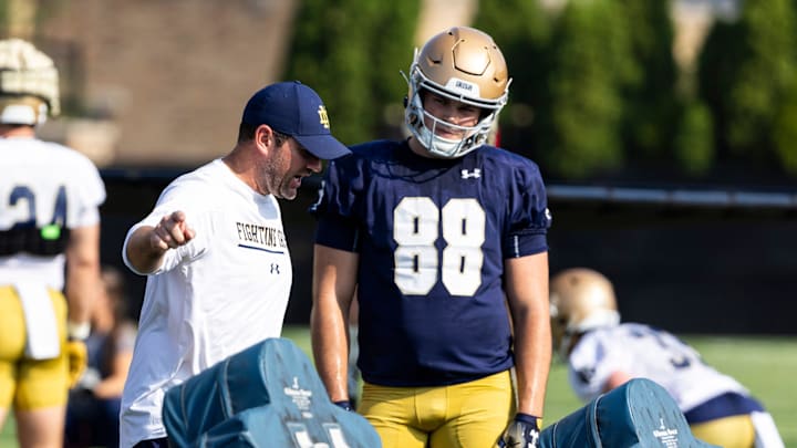 Former Notre Dame football offensive coordinator Gerad Parker with a teaching moment with Mitchell Evans