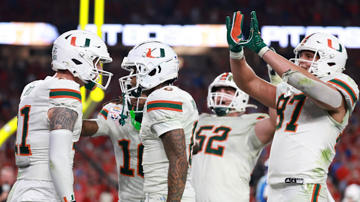 Jan 8, 2026; Glendale, AZ, USA; Miami  Hurricanes quarterback Carson Beck (11) reacts after rushing for a touchdown against the Mississippi Rebels in the second half during the 2026 Fiesta Bowl and semifinal game of the College Football Playoff at State Farm Stadium. Mandatory Credit: Mark J. Rebilas-Imagn Images