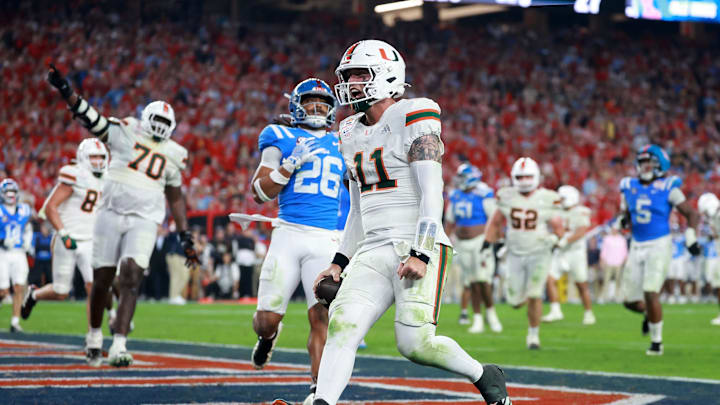 Jan 8, 2026; Glendale, AZ, USA; Miami Hurricanes quarterback Carson Beck (11) rushes for a touchdown against the Mississippi Rebels in the second half during the 2026 Fiesta Bowl and semifinal game of the College Football Playoff at State Farm Stadium. Mandatory Credit: Mark J. Rebilas-Imagn Images Jan 8, 2026; Glendale, AZ, USA; Miami Hurricanes quarterback Carson Beck (11) rushes for a touchdown against the Mississippi Rebels in the second half during the 2026 Fiesta Bowl and semifinal game of the College Football Playoff at State Farm Stadium. Mandatory Credit: Mark J. Rebilas-Imagn Images