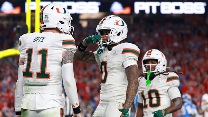 Jan 8, 2026; Glendale, AZ, USA; Miami  Hurricanes quarterback Carson Beck (11) reacts after rushing for a touchdown against the Mississippi Rebels in the second half during the 2026 Fiesta Bowl and semifinal game of the College Football Playoff at State Farm Stadium. Mandatory Credit: Mark J. Rebilas-Imagn Images