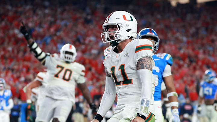 Jan 8, 2026; Glendale, AZ, USA; Miami  Hurricanes quarterback Carson Beck (11) rushes for a touchdown against the Mississippi Rebels in the second half during the 2026 Fiesta Bowl and semifinal game of the College Football Playoff at State Farm Stadium. Mandatory Credit: Mark J. Rebilas-Imagn Images