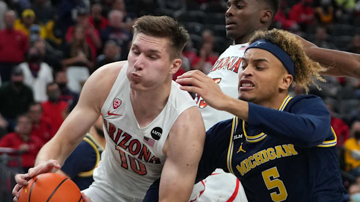Nov 21, 2021; Las Vegas, Nevada, USA; Arizona Wildcats forward Azuolas Tubelis (10) grabs a rebound away from Michigan Wolverines forward Terrance Williams II (5) during the second half at T-Mobile Arena. Mandatory Credit: Stephen R. Sylvanie-Imagn Images Nov 21, 2021; Las Vegas, Nevada, USA; Arizona Wildcats forward Azuolas Tubelis (10) grabs a rebound away from Michigan Wolverines forward Terrance Williams II (5) during the second half at T-Mobile Arena. Mandatory Credit: Stephen R. Sylvanie-Imagn Images