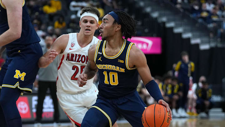 Nov 21, 2021; Las Vegas, Nevada, USA; Michigan Wolverines guard Frankie Collins (10) dribbles ahead of Arizona Wildcats guard Kerr Kriisa (25) during the first half at T-Mobile Arena. Mandatory Credit: Stephen R. Sylvanie-Imagn Images