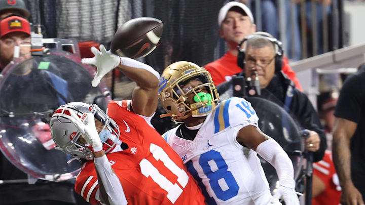 Nov 15, 2025; Columbus, Ohio, USA; Ohio State Buckeyes wide receiver Quincy Porter (11) attempts to catch the ball as UCLA Bruins defensive back Rodrick Pleasant (18) interferes on the play during the second quarter at Ohio Stadium. Mandatory Credit: Joseph Maiorana-Imagn Images Nov 15, 2025; Columbus, Ohio, USA; Ohio State Buckeyes wide receiver Quincy Porter (11) attempts to catch the ball as UCLA Bruins defensive back Rodrick Pleasant (18) interferes on the play during the second quarter at Ohio Stadium. Mandatory Credit: Joseph Maiorana-Imagn Images