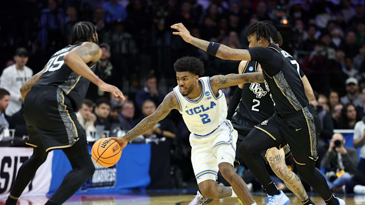 Mar 20, 2026; Philadelphia, PA, USA; UCLA Bruins guard Donovan Dent (2) dribbles the ball against the UCF Knights  in the second half during a first round game of the men's 2026 NCAA Tournament at Xfinity Mobile Arena. Mandatory Credit: Bill Streicher-Imagn Images