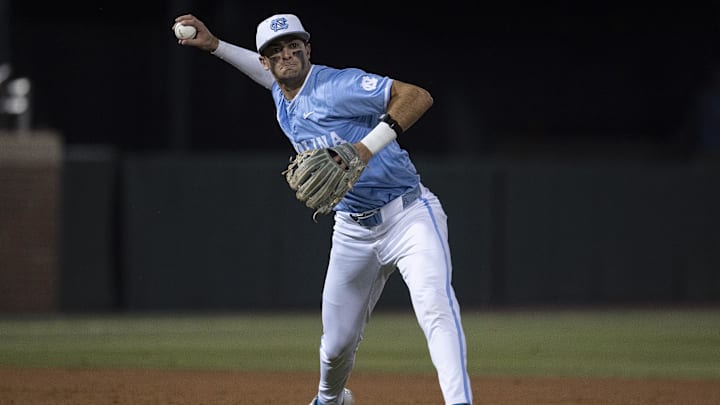 Jun 8, 2024; Chapel Hill, NC, USA; North Carolina Tar Heels Gavin Gallaher (5) makes a throw to first base against the West Virginia Mountaineers in the fifth inning of the DI Baseball Super Regional at Boshamer Stadium. Mandatory Credit: Jeffrey Camarati-Imagn Images

