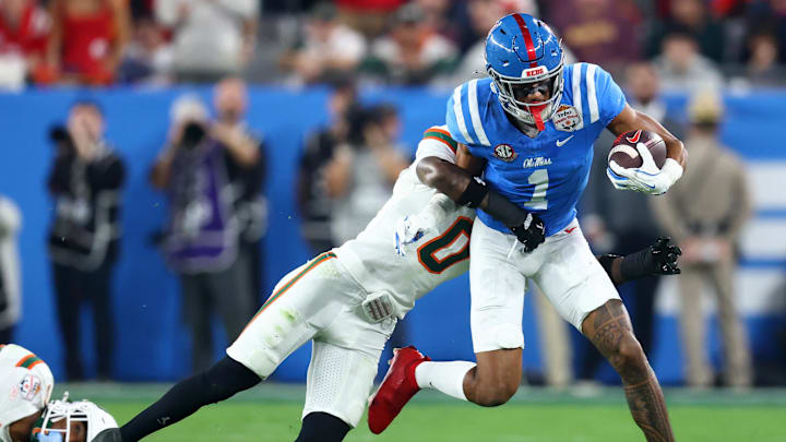 Jan 8, 2026; Glendale, AZ, USA;Mississippi Rebels wide receiver De'zhaun Stribling (1) makes a catch against Miami Hurricanes defensive back Keionte Scott (0)  in the second half during the 2026 Fiesta Bowl and semifinal game of the College Football Playoff at State Farm Stadium. Mandatory Credit: Mark J. Rebilas-Imagn Images