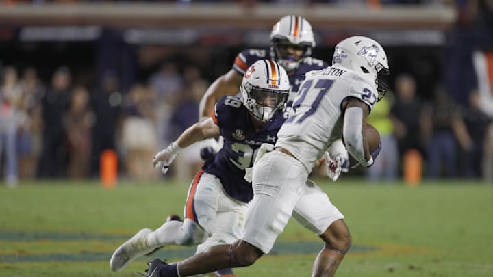 Sep 16, 2023; Auburn, Alabama, USA; Samford Bulldogs running back Mychael Hamilton (27) tries to get past Auburn Tigers safety Griffin Speaks (39) during the third quarter at Jordan-Hare Stadium. Mandatory Credit: John Reed-USA TODAY Sports