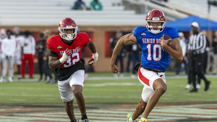 Jan 29, 2026; Mobile, AL, USA; American quarterback Taylen Green (10) of Arkansas runs the ball with American linebacker Xavian Sorey (32) of Arkansas chasing him during American Senior Bowl practice at Hancock Whitney Stadium. Mandatory Credit: Vasha Hunt-Imagn Images