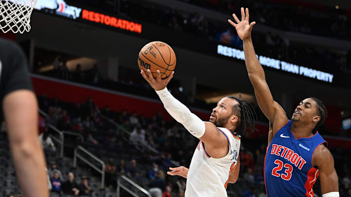 Nov 1, 2024; Detroit, Michigan, USA; New York Knicks guard Jalen Brunson (11) drives past Detroit Pistons guard Jaden Ivey (23) for a layup in the third quarter at Little Caesars Arena. Mandatory Credit: Lon Horwedel-Imagn Images