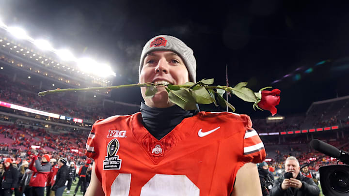 Dec 21, 2024; Columbus, Ohio, USA; Ohio State Buckeyes quarterback Will Howard (18) celebrates the win as he carries a rose after the game against the Tennessee Volunteers at Ohio Stadium. Mandatory Credit: Joseph Maiorana-Imagn Images