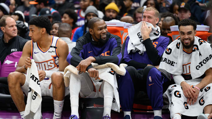 Jan 16, 2025; Washington, District of Columbia, USA; Phoenix Suns forward Kevin Durant (35) reacts on the bench with center Mason Plumlee (22), and guard Tyus Jones (21) during the fourth quarter against the Washington Wizards at Capital One Arena. Mandatory Credit: Reggie Hildred-Imagn Images