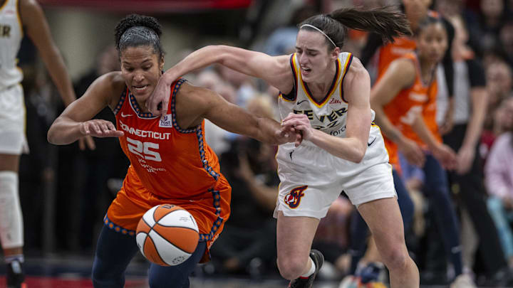 Connecticut Sun forward Alyssa Thomas (25) knocks the ball away from Indiana Fever guard Caitlin Clark (22) during the second half of an WNBA basketball game, Monday, May 20, 2024, at Gainbridge Fieldhouse.