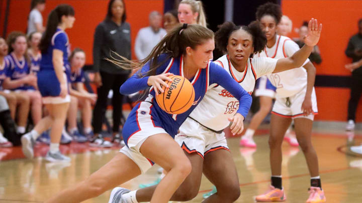 Cleveland's guard Lauren Hurst (11) tires to move the ball towards the basket as Blackman's forward Tishana Moore (15) guards her during the Girls Class 4A sectional basketball game at Blackman, on Saturday, March 2, 2024.