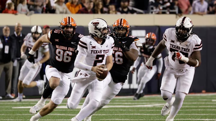 Texas Tech's Behren Morton runs the ball against Oklahoma State's Kody Walterscheid and Xavier Ross while Texas Tech's Sterling Porcher looks on during an NCAA football game on Saturday, Nov. 23, 2024, in Stillwater, Okla.