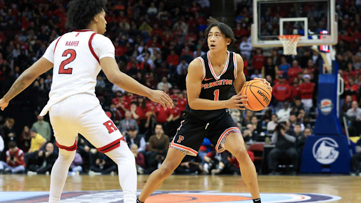 Dec 21, 2024; Newark, New Jersey, USA; St. John's transfer target Xaivian Lee (1) looks to pass while being defended by Rutgers Scarlet Knights guard Dylan Harper (2) during the second half at Prudential Center. Mandatory Credit: Tom Horak-Imagn Images