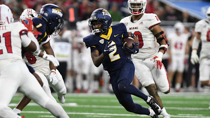 Dec 2, 2023; Detroit, MI, USA;  Toledo Rockets wide receiver Junior Vandeross III (2) runs the ball upfield after catching a pass against the Miami (OH) Redhawks in the second quarter at Ford Field. Mandatory Credit: Lon Horwedel-Imagn Images