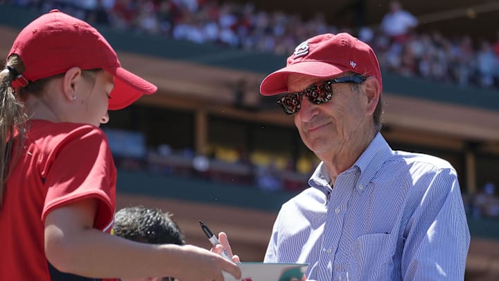 Jun 3, 2018; St. Louis, MO, USA; St. Louis Cardinals principal owner and chairman Bill DeWitt Jr. signs an autograph for a young fan during the seventh inning against the Pittsburgh Pirates at Busch Stadium. Mandatory Credit: Scott Rovak-Imagn Images