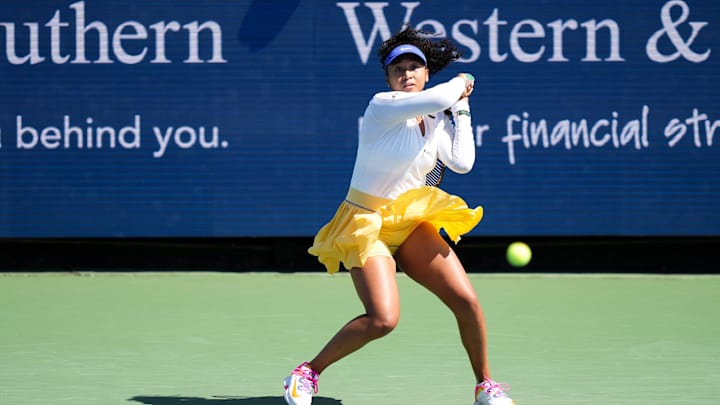 Naomi Osaka sends the ball back to Shuai Zhang during their match on Center Court at the 2022