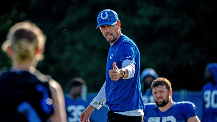 Indianapolis Colts head coach Shane Steichen greets warming-up players during day #9 practice of