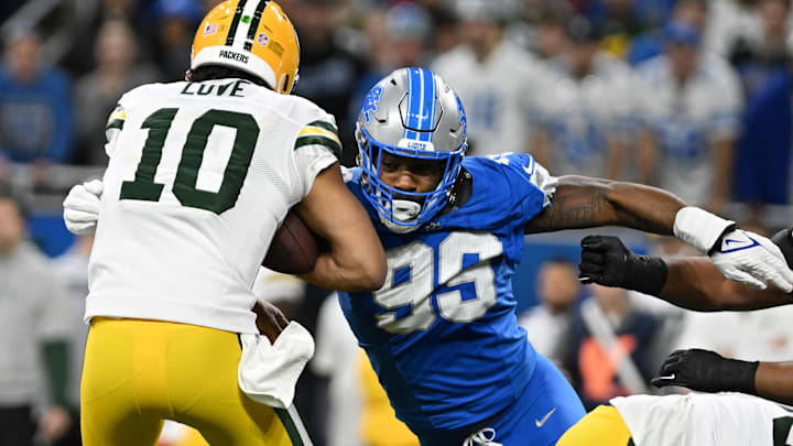 Dec 5, 2024; Detroit, Michigan, USA; Green Bay Packers quarterback Jordan Love (10) gets sacked by Detroit Lions defensive end Za'Darius Smith (99) in the first quarter at Ford Field. Mandatory Credit: Lon Horwedel-Imagn Images