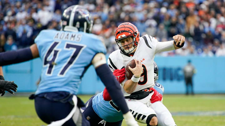 Cincinnati Bengals quarterback Joe Burrow (9) is tackled by Tennessee Titans defensive tackle