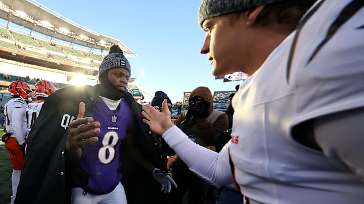 Dec 14, 2025; Cincinnati, Ohio, USA;  Cincinnati Bengals quarterback Joe Burrow (9) and Baltimore Ravens quarterback Lamar Jackson (8) meet after the game at Paycor Stadium. Mandatory Credit: Joseph Maiorana-Imagn Images