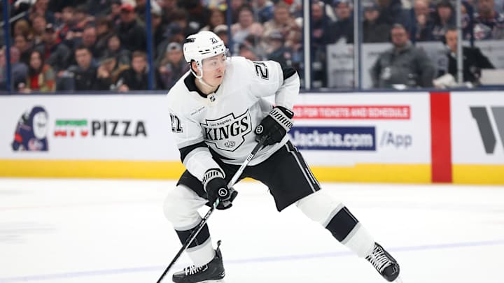Jan 25, 2025; Columbus, Ohio, USA;  Los Angeles Kings defenseman Jordan Spence (21) controls the puck during the third period against the Columbus Blue Jackets at Nationwide Arena. Mandatory Credit: Joseph Maiorana-Imagn Images