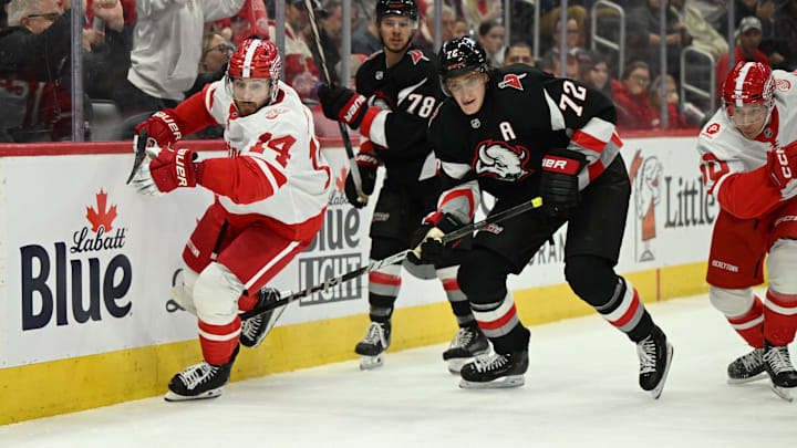 Mar 12, 2025; Detroit, Michigan, USA; Detroit Red Wings center Tyler Motte (14) and Buffalo Sabres center Tage Thompson (72) race for the puck in the second period at Little Caesars Arena. Mandatory Credit: Lon Horwedel-Imagn Images